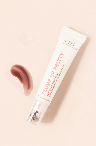 Tube of E.H.F. Plump Up Pretty lip balm on a beige background