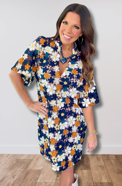Woman wearing a floral dress with a plain background