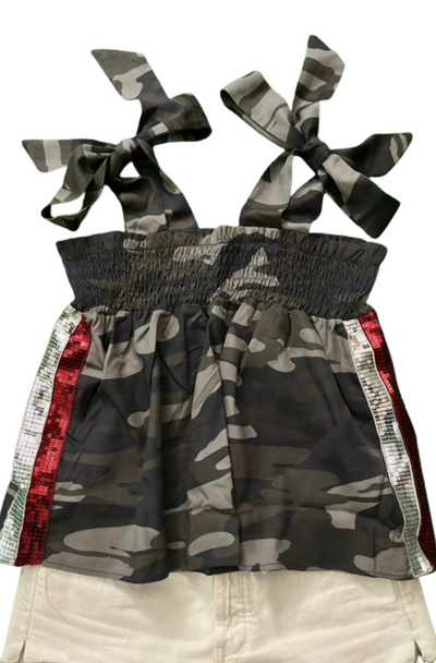 Camouflage dress with bows and red accents on a white background