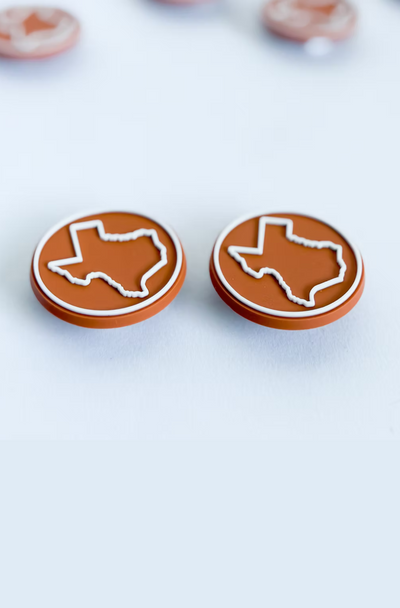 Pair of burnt orange Texas boot buttons with white state outline, perfect for University of Texas Longhorns fans.