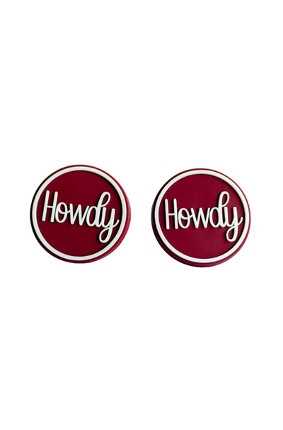 Pair of maroon 'Howdy' boot buttons with white script lettering and border - a fun nod to Texas A&M tradition.
