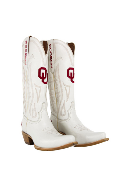 Oklahoma Sooners white leather cowboy boots featuring crimson "OU" logos and "Boomer Sooner" text on the pull tabs. Perfect for college football fans and game day outfits with a Western twist. Stylish way to show team spirit.